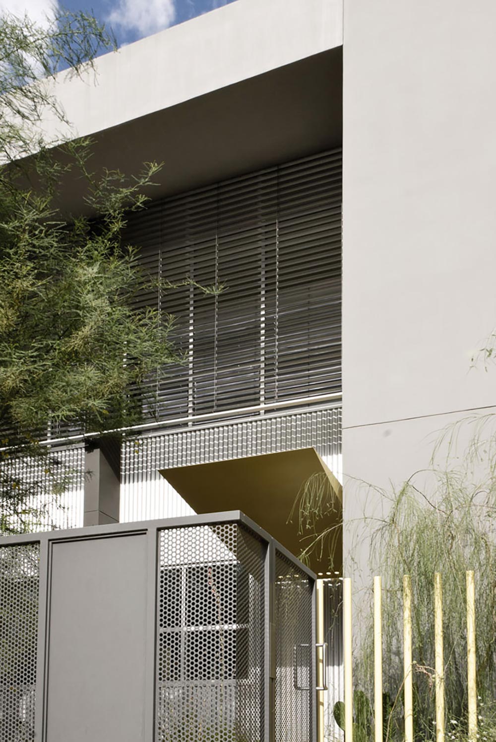 Sun-control louvers shield the upper-level studio.