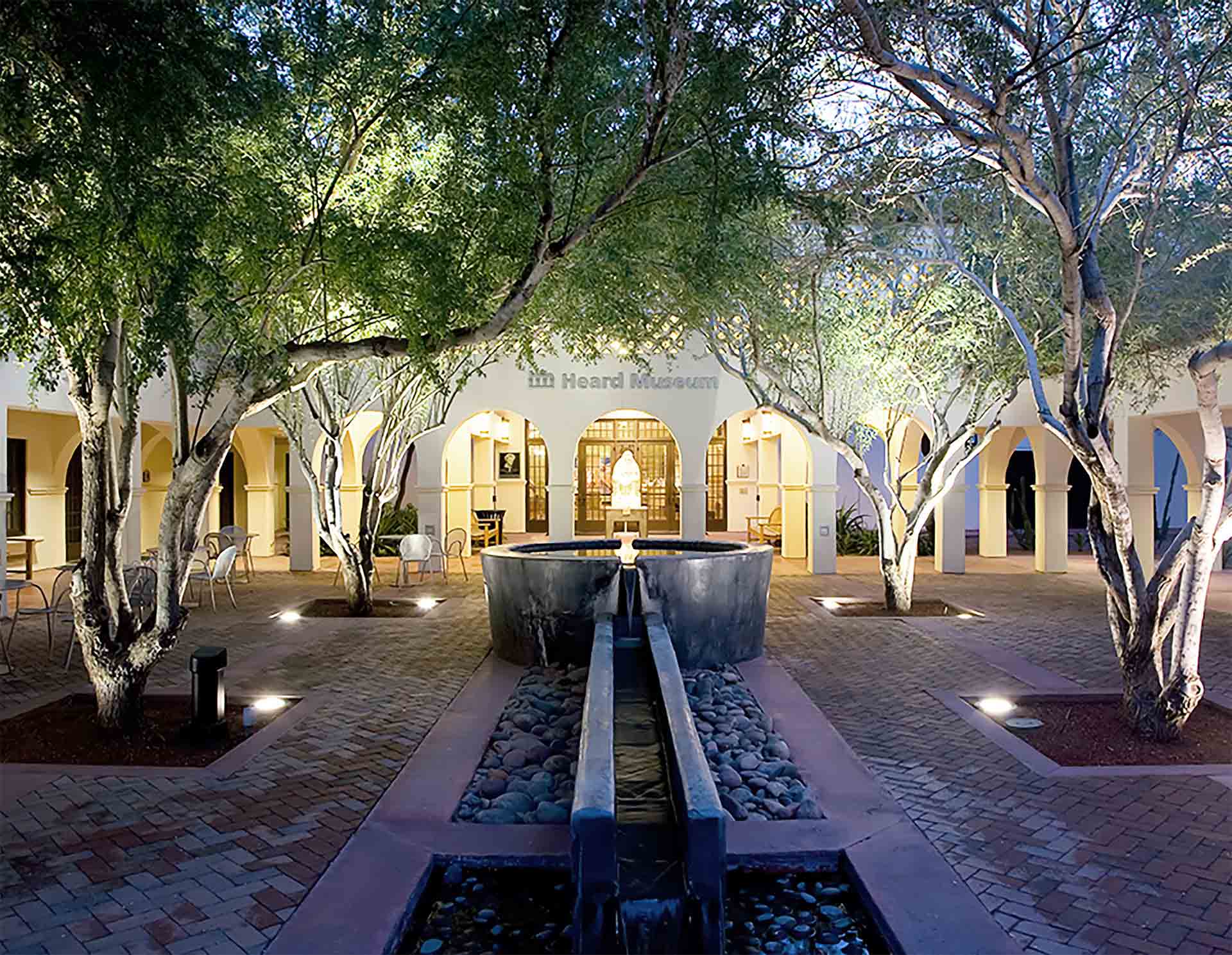 New main courtyard and fountain, flanked by mature ironwood trees.