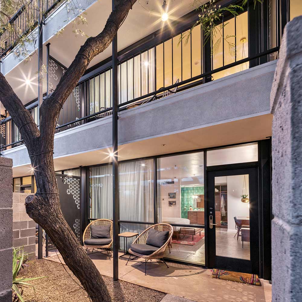 Former office suites repurposed as hotel rooms with patios.